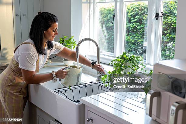 filling up the kettle - kettle stock pictures, royalty-free photos & images