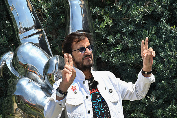 British musician Ringo Starr poses in front of the stainless steel "Peace and Love" sculpture, which he designed and donated to Beverly Hills in...