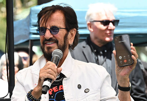 Drummer Ringo Starr holds up his phone connected with "Mac Macca," a nickname for Paul McCartney, and tells the band McCartney approves of their...