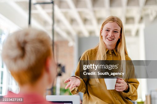Young professionals engage in creative teamwork in a Scandinavian style office setting Young professionals engage in creative teamwork in a Scandinavian style office setting