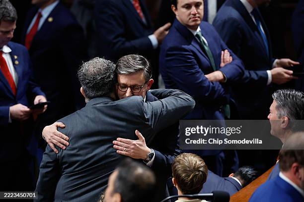 Speaker of the House Mike Johnson embraces a fellow legislator as the House votes on the One Big Beautiful Bill Act in the House of Representatives...