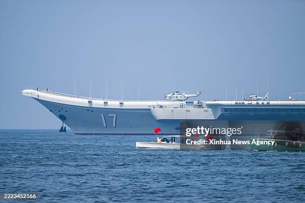 Local people taking ferries see off the Chinese People's Liberation Army PLA Navy fleet in Hong Kong, south China, July 7, 2025. A fleet of the...