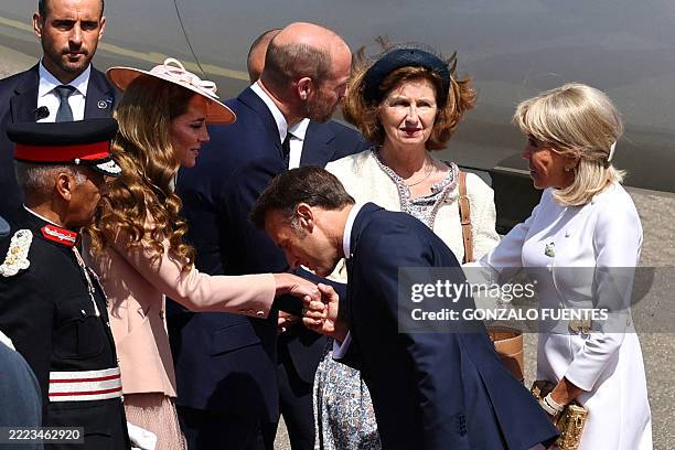 Britain's Prince William, Prince of Wales and Britain's Catherine, Princess of Wales greet France's President Emmanuel Macron and his wife Brigitte...