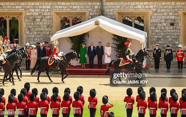 Britain's Queen Camilla, Britain's King Charles III, France's President Emmanuel Macron and his wife Brigitte Macron stand during a ceremonial...