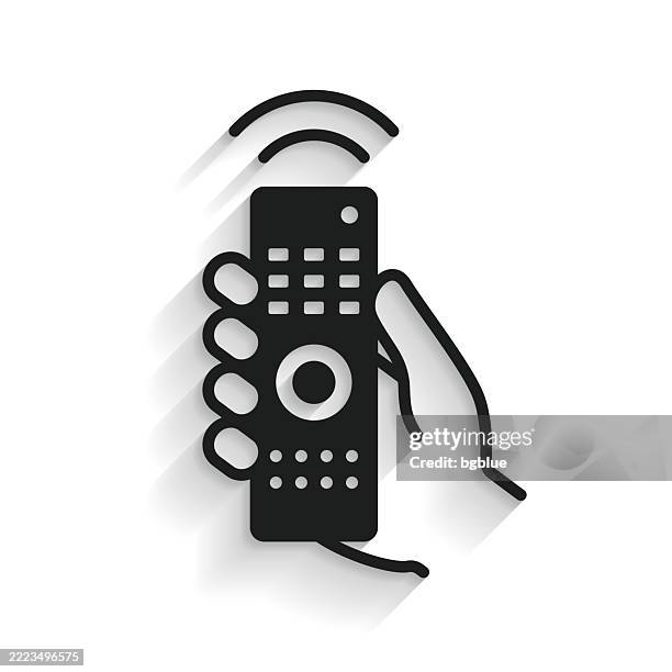 hand with remote control. icon with long shadow on white background - hand tv controller stock illustrations