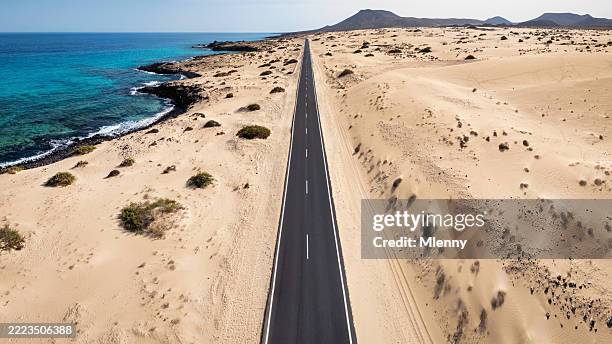 endless road through corralejo sand dunes fuerteventura canary islands spain - fuerteventura beach stock pictures, royalty-free photos & images