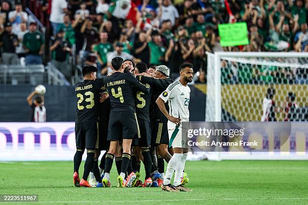 Jesús Gallardo of Mexico, Edson Álvarez, Johan Vásquez and others all celebrate a goal while Ali Majrashi of Saudi Arabia stands in defeat during the...