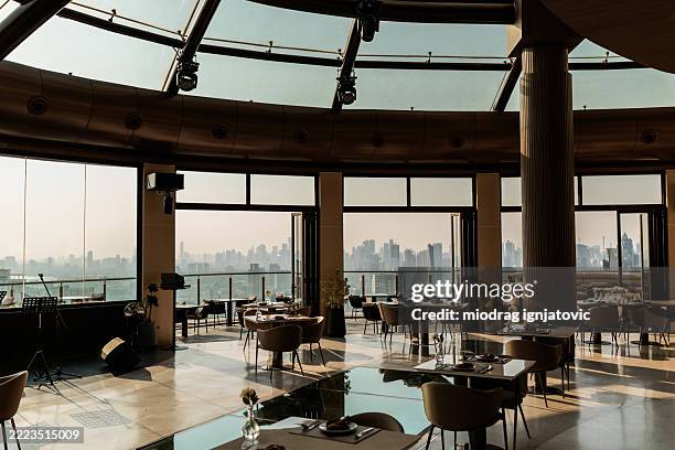 sunlit elegant bar terrace with city and sky views - gymnastics bar stock pictures, royalty-free photos & images