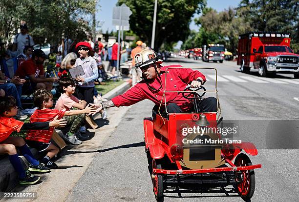 Sierra Madre Fire Chief Brent Bartlett greets youngsters during the Sierra Madre Independence Day Parade, not far from the Eaton Fire burn zone, on...