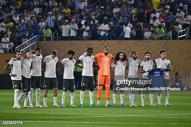 Chelsea FC players take a moment of silence before the match as they hold a jersey in honor of Diego Jota and his brother Andre Silva who passed away...