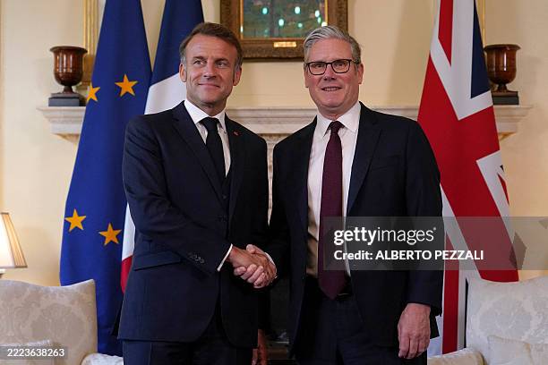 Britain's Prime Minister Keir Starmer shakes hands with France's President Emmanuel Macron inside 10 Downing Street in London, on July 9 ahead of a...
