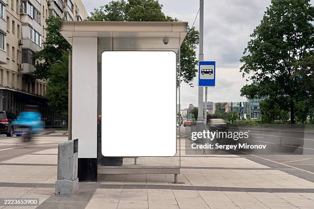 glass bus stop mockup with vertical blank banner on city sidewalk near road and bus sign - bus stop stock pictures, royalty-free photos & images