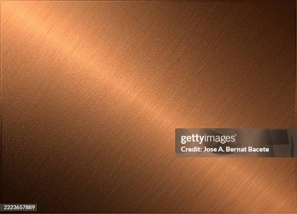 fine rough textures of a shiny light gold colored metal sheet. - messing stockfoto's en -beelden