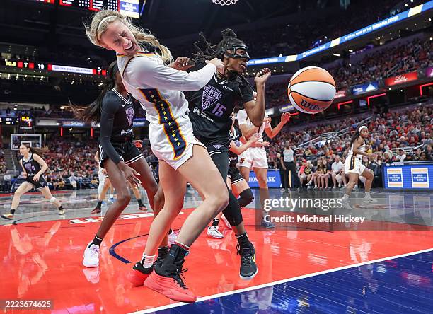 Sophie Cunningham of the Indiana Fever and Tiffany Hayes of the Golden State Valkyries collide under the basket during the first half at Gainbridge...