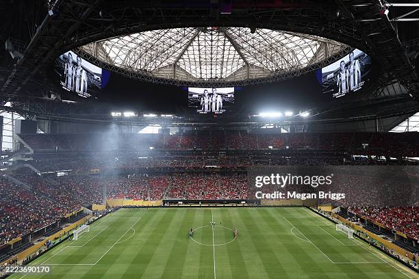 Players of FC Bayern München and Paris Saint-Germain line up to observe a moment of silence in tribute to football players Diogo Jota and his brother...