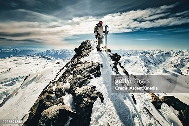 backcountry skier on mountain top at sunset - professional skier stock pictures, royalty-free photos & images