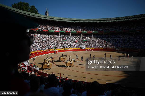 Matadors and their assistants enter the bullring before a bullfight at the San Fermin festival in Pamplona, northern Spain, on July 9, 2025....