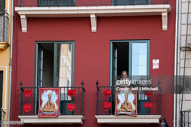 Woman looks from her balcony at Plaza Consistorial ahead of the start of San Fermin running of the bulls on July 05, 2025 in Pamplona, Spain. During...