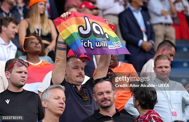 Fan of Netherlands holds up a rainbow flag which reads "Yes, I will" during the UEFA Women's EURO 2025 Group D match between Wales and Netherlands at...