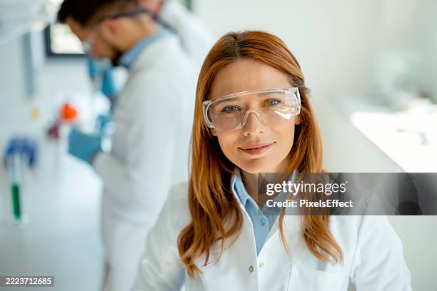 confident female researcher in clinical lab - scientist portrait stock pictures, royalty-free photos & images
