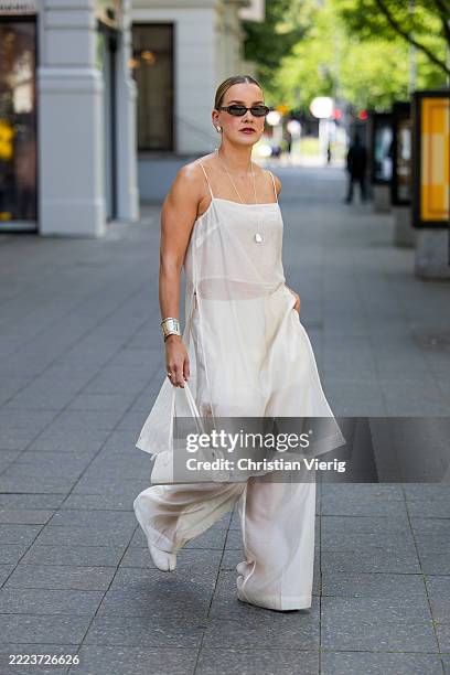 Tina Haase wears white H&M Edition transparent dress & pants, Margiela Tabi ballerinas, silver bracelet, white Mango baguette bag, Le Specs...