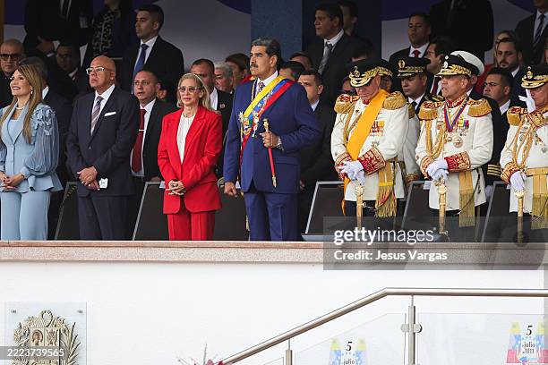 President of Venezuela Nicolas Maduro and his wife and First Lady Cilia Flores look at the military parade as part of 214th anniversary of...