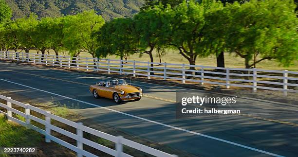 vintage convertible car on a sunny day with mountains in the background - collectors car stock pictures, royalty-free photos & images