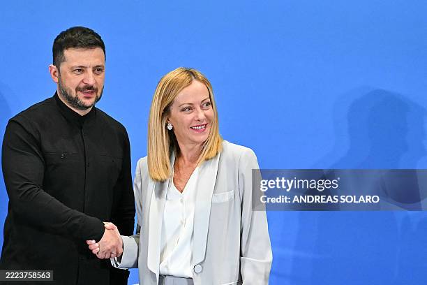 Ukraine's President Volodymyr Zelensky shakes hands with Italy's Prime Minister Giorgia Meloni at the end of their press conference, as part of The...