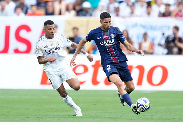 Achraf Hakimi right-back of PSG and Morocco and Kylian Mbappe centre-forward of Real Madrid and France compete for the ball during the FIFA Club...