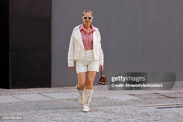 Influencer Iryna Thater wearing a red-white checked blouse by Claudie Pierlot, white shorts and a white jacket by Iro Paris, white lace-up boots by...