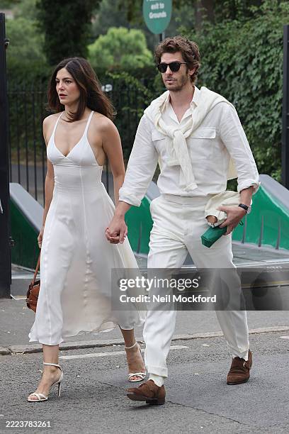 Monica Barbaro and Andrew Garfield arrive at All England Lawn Tennis and Croquet Club on July 06, 2025 in London, England.