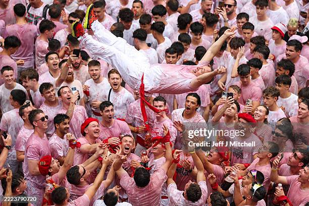 Revellers throw people in the air during the opening day or 'Chupinazo' of the San Fermin Running of the Bulls fiesta on July 06, 2025 in Pamplona,...