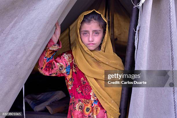 sad afghan girl looking out from a tent - afghanistan bildbanksfoton och bilder