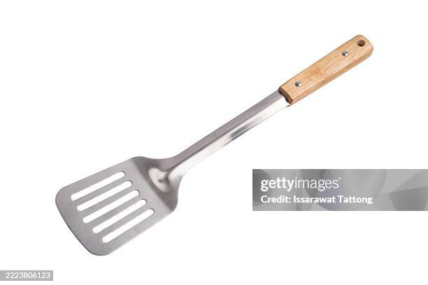 a silver spatula with a wooden handle - spatula stock pictures, royalty-free photos & images