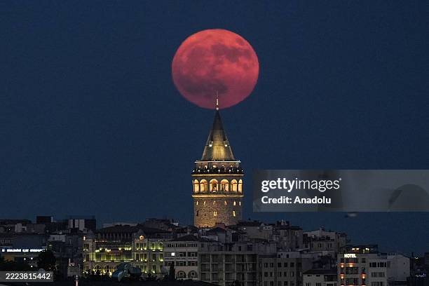 Full moon is seen rising behind the iconic Galata Tower, illuminating the night sky in Istanbul, Turkiye, on July 10, 2025.