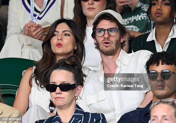 Monica Barbaro, Andrew Garfield and Matthew Broome, wearing Ralph Lauren, attend day seven of the Wimbledon Tennis Championships at the All England...