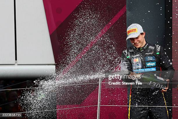Second placed Oscar Piastri of Australia and McLaren sprays Champagne on the podium during the F1 Grand Prix of Great Britain at Silverstone Circuit...