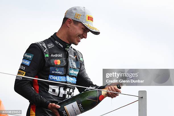 Race winner Lando Norris of Great Britain and McLaren sprays Champagne on the podium during the F1 Grand Prix of Great Britain at Silverstone Circuit...