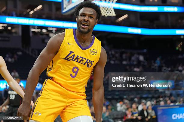 Bronny James of the Los Angeles Lakers reacts after a slam dunk against the Miami Heat during the first half of the California Classic summer league...