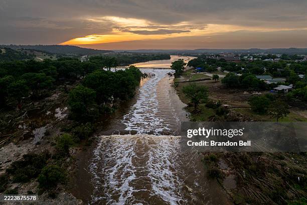 In an aerial view, the sun sets over the Guadalupe River on July 06, 2025 in Kerrville, Texas. Heavy rainfall caused severe flooding along the...