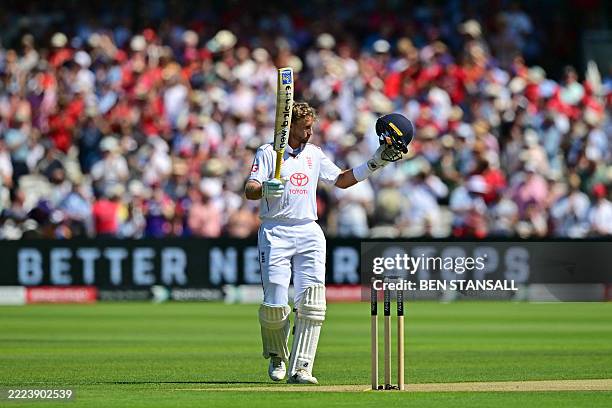 England's Joe Root reacts to reaching his century on the second day of the third cricket test match between England and India at Lord's cricket...