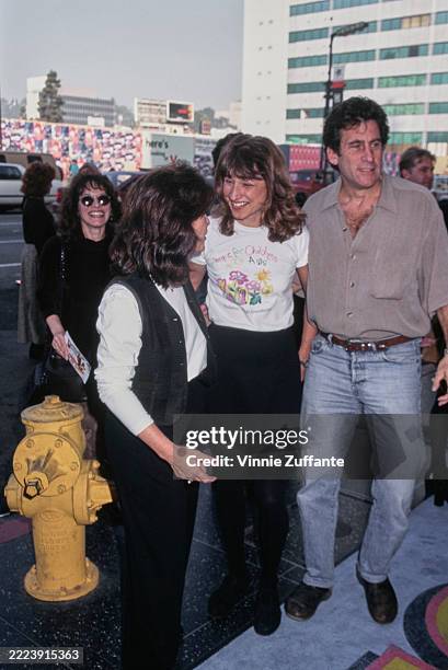 American actor and film director Paul Michael Glaser, wearing a grey short-sleeve shirt and jeans, and his partner, Tracy, who wears a 'Elizabeth...