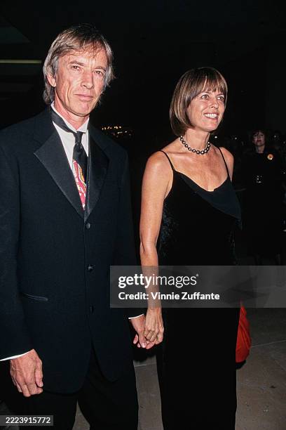 American actor Scott Glenn, wearing a tuxedo and tie with a wingtip collar, and his wife, Carol Schwartz, who wears a black dress, attend the 12th...
