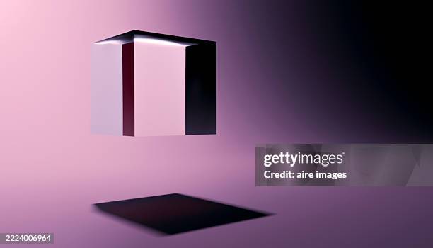 translucent cube floating over purple surface casting shadow - translucent cube stock pictures, royalty-free photos & images