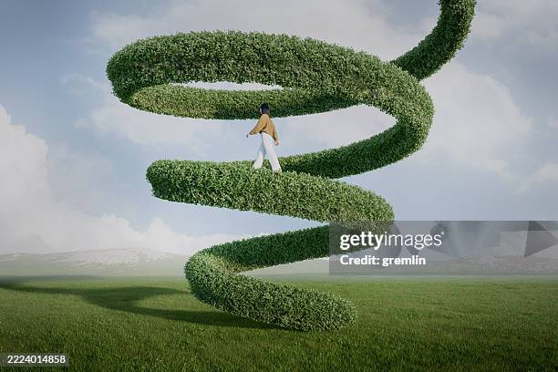 abstract image of woman walking up the green structure - a escada do sucesso imagens e fotografias de stock