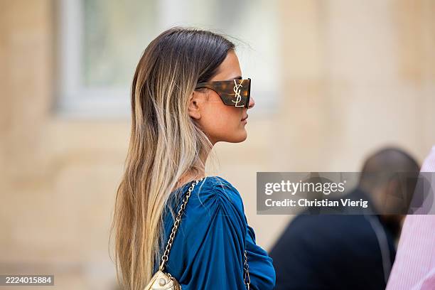 Guest wears blue dress YSL sunglasses, bag outside Tony Ward during the Haute Couture Fall/Winter 2025/2026 as part of Paris Fashion Week on July 07,...