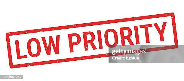 low priority - red rubber stamp on white background - low priority stock illustrations