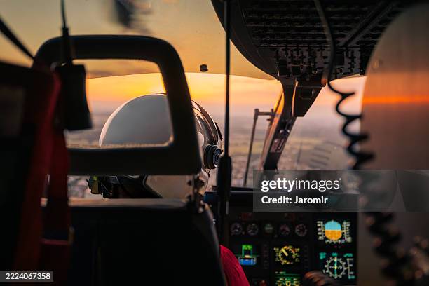 flying helicopter of emergency medical service - rettungshubschrauber stock-fotos und bilder