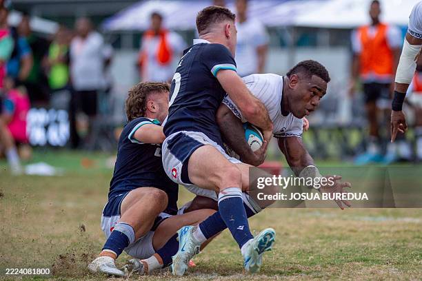 Scotland's Fergus Burke tackles Fiji's Josua Tuisova during the rugby test match between Fiji and Scotland at HFC Bank Stadium in Suva on July 12,...