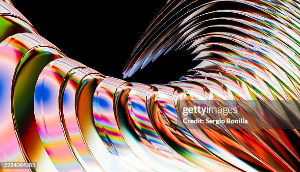 abstract metallic surfaces with vibrant, flowing rainbow reflections against a black background. 3d rendering - rainbow reflection stock illustrations